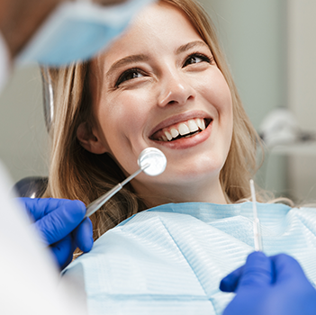 Smiling woman in dentist chair 