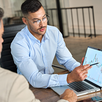 Man shows off stock portfolio on laptop compter